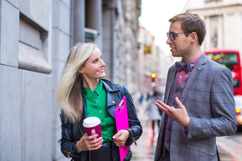 young couple drinking coffee outdoors
