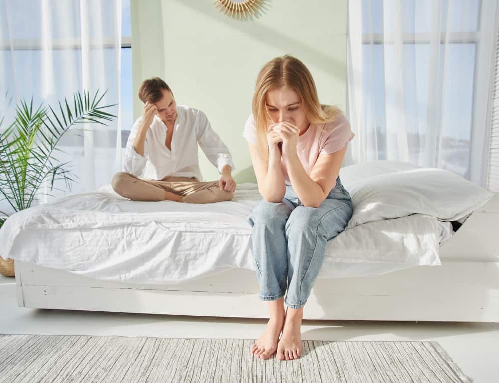 couple misunderstanding while sitting on the bed