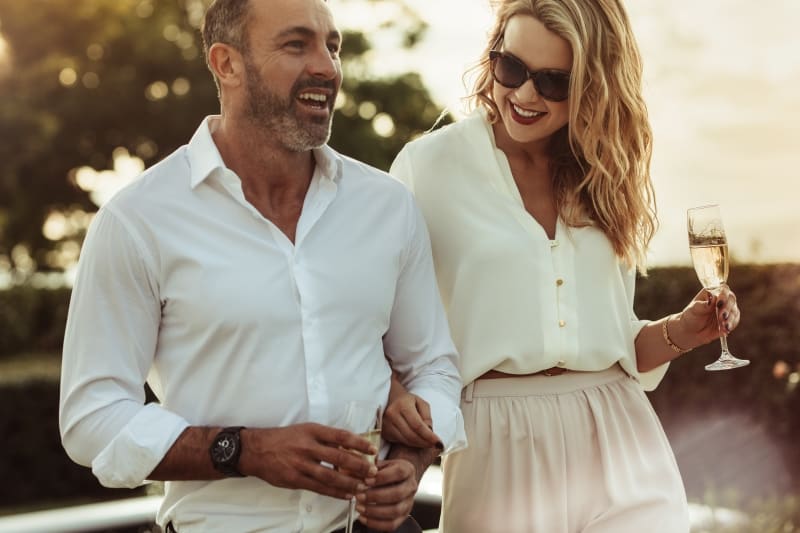 couple walk while drinking wine