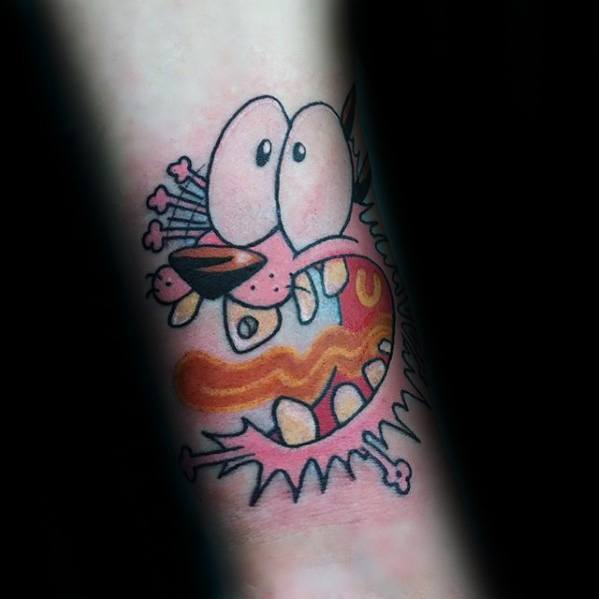 Tattoo of Courage the Cowardly Dog in a freaked-out expression with bulging eyes and a gory, ripped-skin cartoon effect.