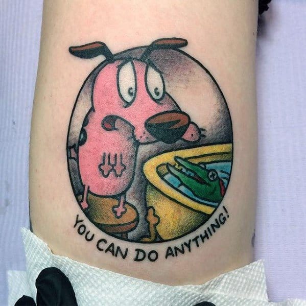 Courage the Cowardly Dog tattoo showing him nervously facing a green creature in a tub, with the words "You Can Do Anything!" below.