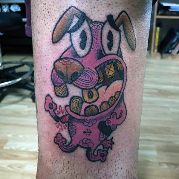 Abstract-style Courage the Cowardly Dog tattoo with swirling patterns and a distorted, expressive face on the lower leg.