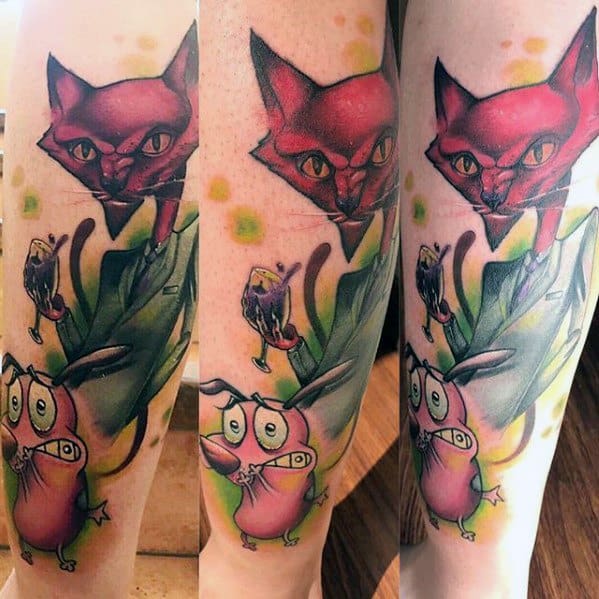 Colorful tattoo of Courage the Cowardly Dog looking scared with a large red cat looming above and abstract leaves surrounding the scene.