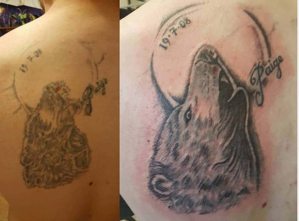 Cover-up tattoo featuring a detailed howling wolf, with the name 'Paige' and the date '19.7.08' inked around the wolf's head