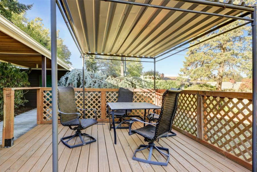 wood deck patio with metal sheet pergola