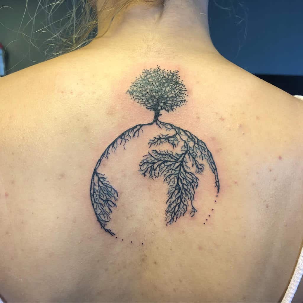 A symbolic tree and earth tattoo representing growth, roots, and the unbreakable bond between mother and daughter.