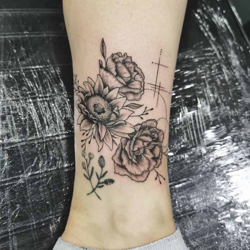 Tattoo of a sunflower and two carnation with dotted lines and small sprigs