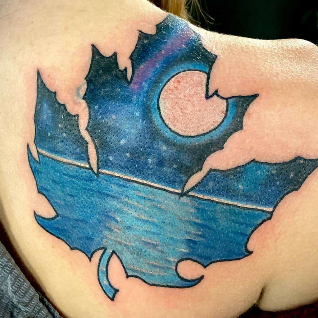Colorful tattoo of a night sky over the ocean, framed within a torn maple leaf design, featuring a bright moon and deep blue hues