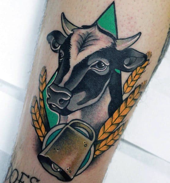 Traditional-style cow tattoo with bold lines, golden wheat, green background, and a bell, blending farm and vintage themes.
