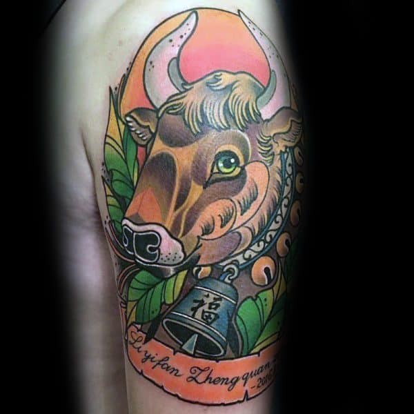 Colorful cow tattoo with bold outlines, vibrant leaves, a bell with Chinese character, and a glowing sunset background.