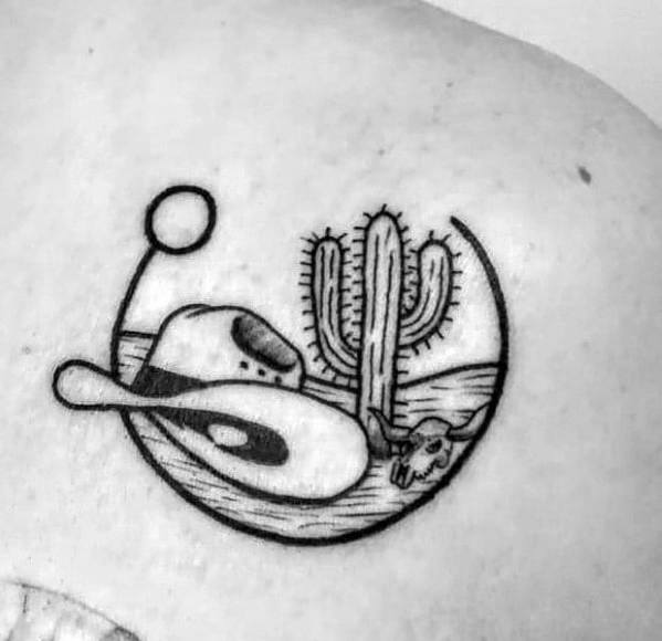 Minimalist black ink tattoo of a cowboy hat, lasso, cactus, and a bull skull within a circular frame, depicting a simple Western desert scene.