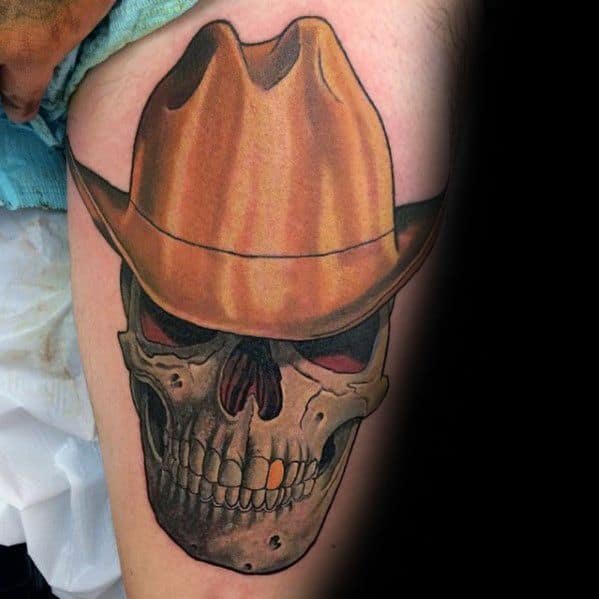 Tattoo of a menacing skull with dark eye sockets wearing a detailed brown cowboy hat, done in a realistic style with shading and texture.