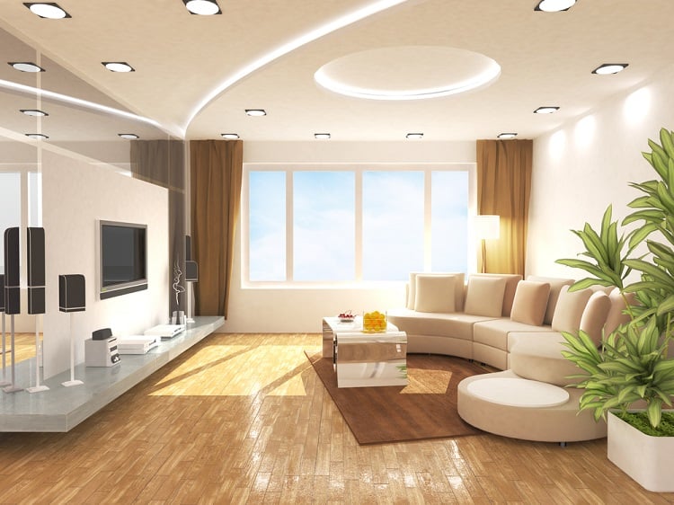 The ceiling features cove lighting with recessed lights, creating a bright and modern ambiance in a spacious living room