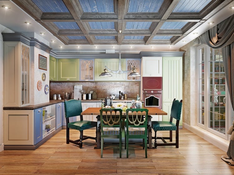 Cozy kitchen with colorful cabinets, wooden dining set under a decorative ceiling adorned with recessed lighting