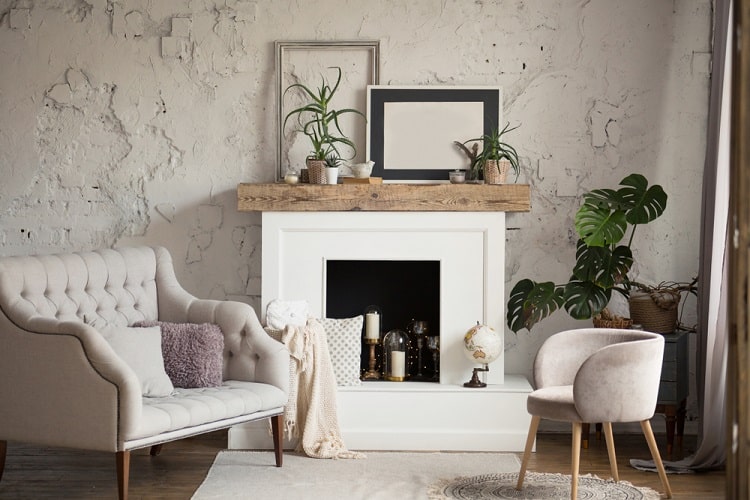 classic white fireplace with wood mantel and textured concrete walls