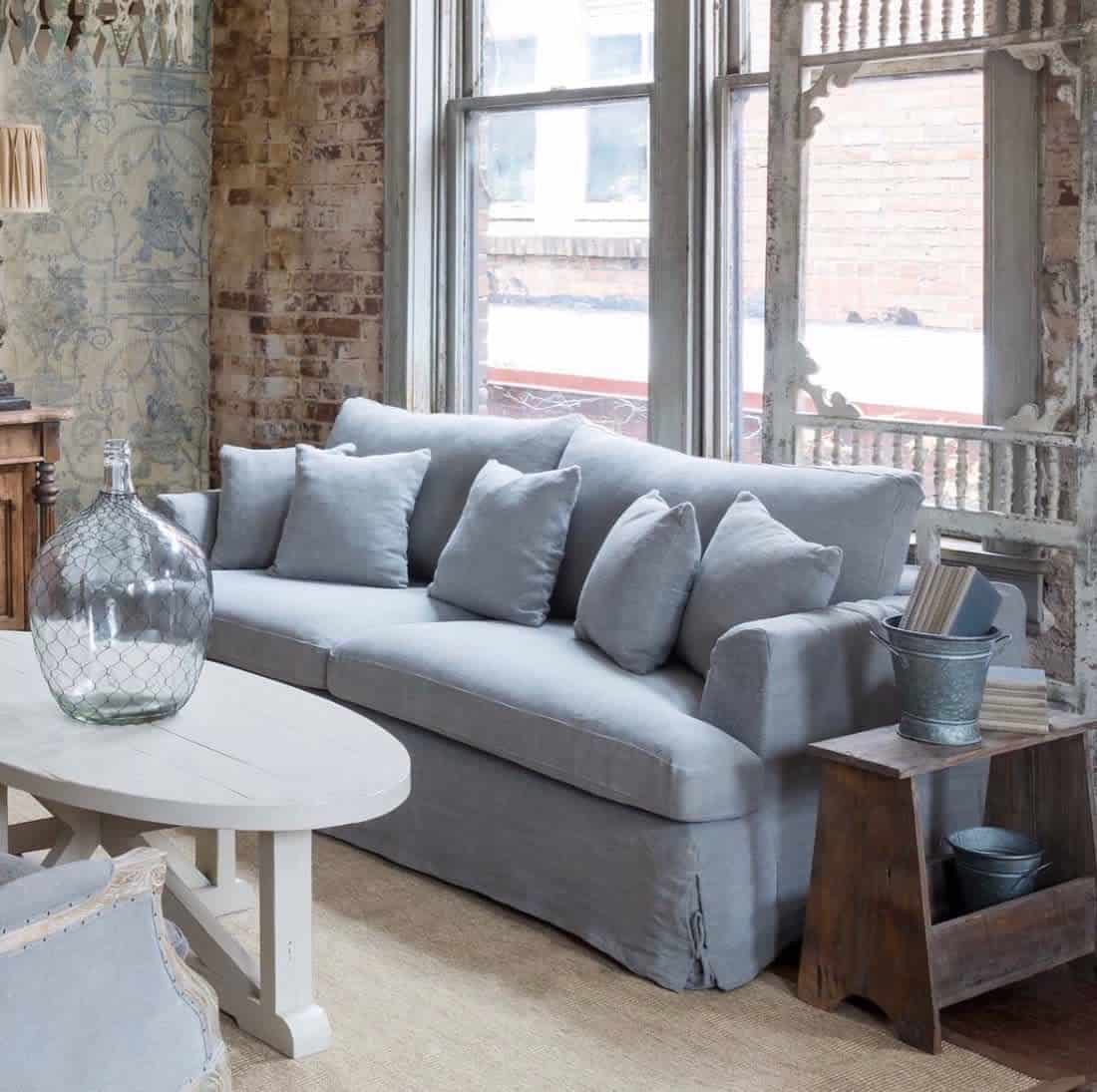 rustic living room blue sofa white table exposed brick wall