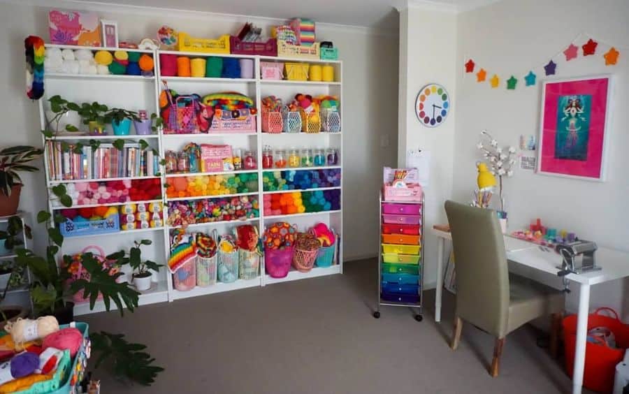 kids craft room with white cabinet wall storage and desk