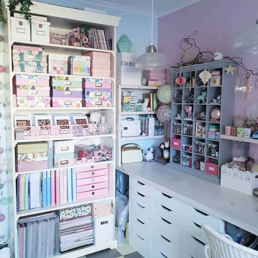 pastel color craft room with cabinet storage and purple accent wall