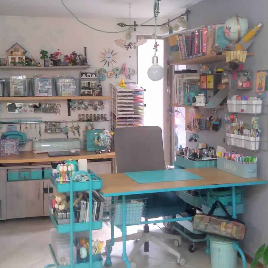 Vibrant craft room with turquoise accents, organized shelves, storage carts, and a creative workspace full of supplies