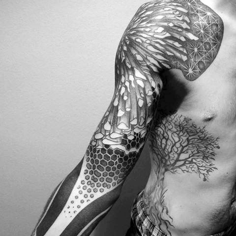 Black and white tattoo sleeve with geometric and abstract designs on a person's arm