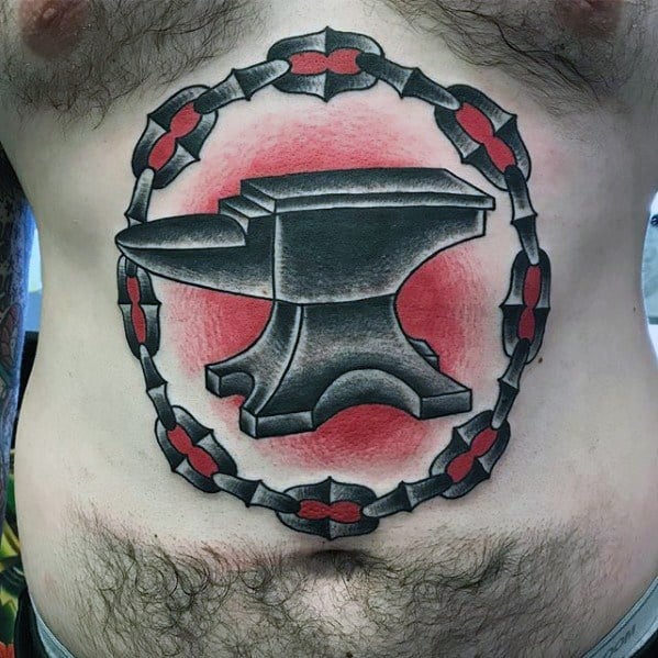 Large anvil tattoo on the stomach with bold black shading, encircled by a red and black chain and red background glow for dramatic impact.