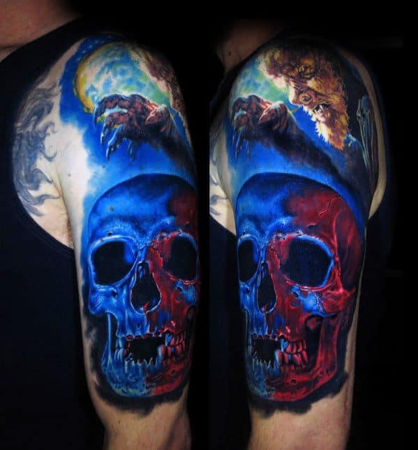 A detailed upper arm tattoo featuring a red and blue skull with a creature above