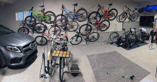 Garage with multiple bikes mounted on wall racks and a clean, organized storage setup.