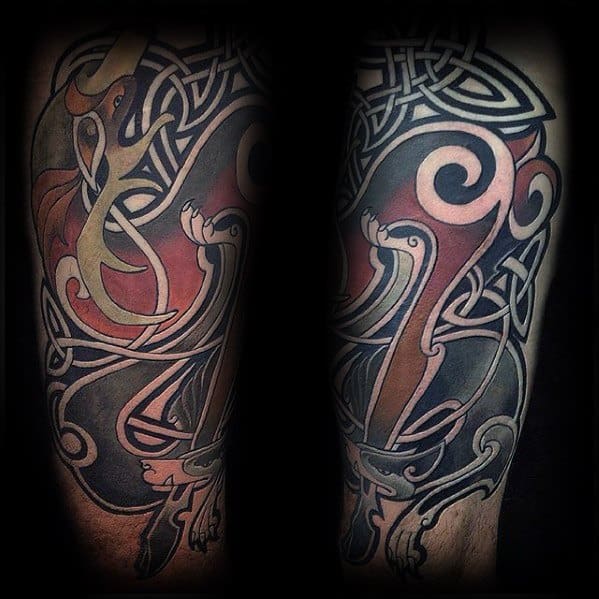 Colorful Celtic wolf tattoo sleeve with bold knotwork, swirling patterns, and rich red, gold, and black tones forming a dynamic design.