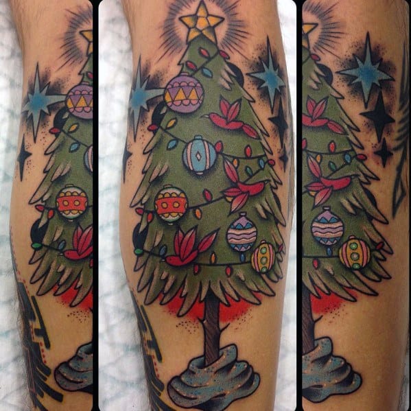 Traditional Christmas tree tattoo with bold outlines, colorful ornaments, twinkling stars, and a golden star on top, creating a festive holiday look.