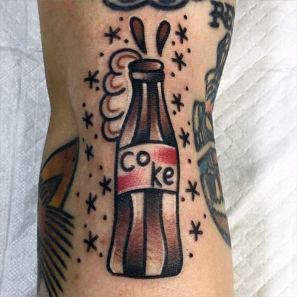 Traditional-style Coca-Cola bottle tattoo with bold outlines, a playful fizzing effect, and vintage-inspired details for a classic and fun design.