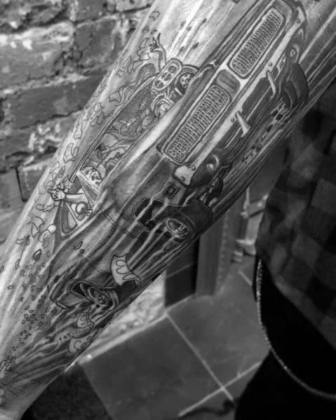 Black and grey Dodge muscle car tattoo with cartoon characters and intricate details, creating a unique and dynamic sleeve design.