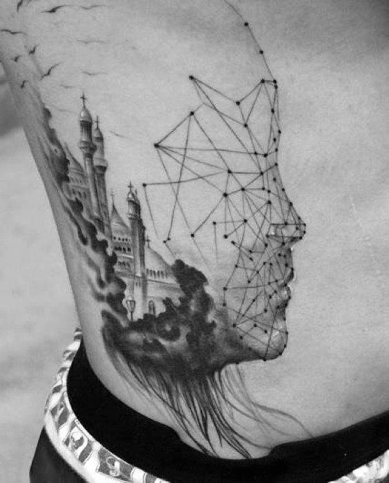 Tattoo of a castle emerging from smoke within a geometric human face outline made of dots and lines, symbolizing dream and structure.