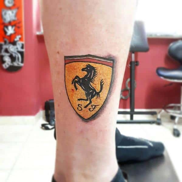 Iconic Ferrari shield tattoo featuring the prancing black horse, yellow background, and SF initials, symbolizing speed, power, and prestige.
