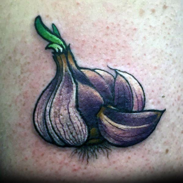 Vibrant purple garlic tattoo with green sprouts and detailed shading, creating a bold and eye-catching design with a realistic touch.