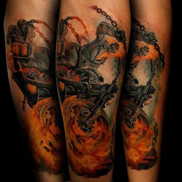 Ghost Rider forearm tattoo with a flaming motorcycle, blazing wheels, and the rider wielding a fiery chain in a dynamic pose.