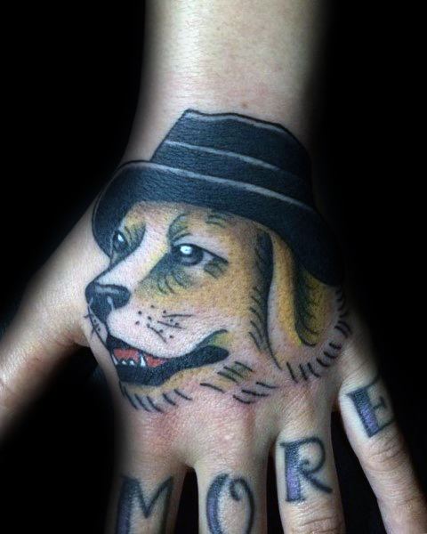 Traditional-style Golden Retriever tattoo on the hand, featuring bold outlines, shading, and a fedora for a unique, vintage-inspired look.