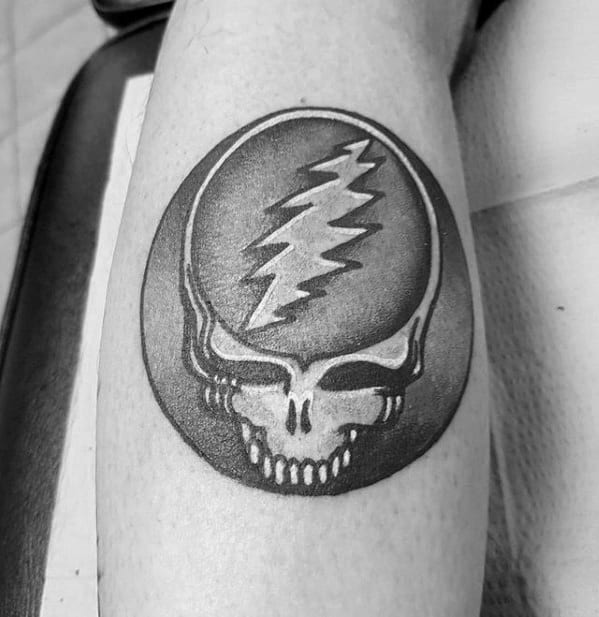 Black and grey Grateful Dead Steal Your Face skull tattoo with a bold lightning bolt, shaded for depth and dimension.