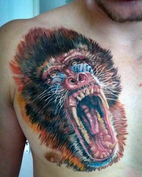 Hyper-realistic baboon chest tattoo with intense shading, lifelike fur details, and a fierce open-mouthed expression for a powerful design.