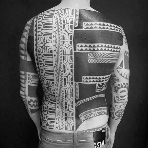 Person with a large, intricate black and white geometric tattoo covering their back