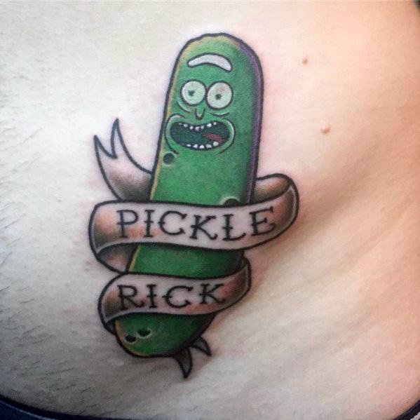 Pickle Rick tattoo with a classic banner wrapped around, featuring bold shading and a fun, cartoon-style design on the chest.