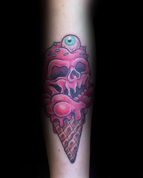 Tattoo of a melting red skull ice cream cone with sprinkles and an eerie eyeball on top, blending horror and surreal design elements.