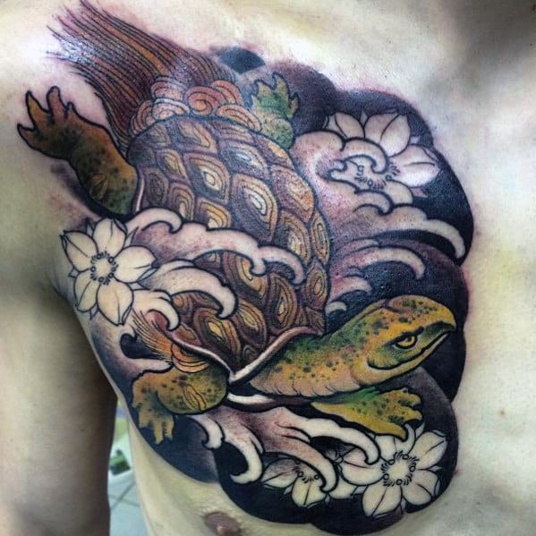 Japanese turtle tattoo on the chest with flowing waves, floral accents, and intricate shell details, symbolizing longevity and strength.