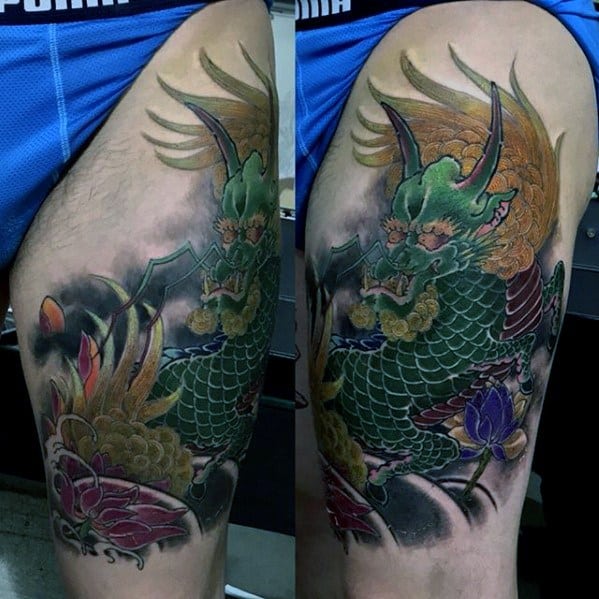 Vibrant Kirin thigh tattoo with green scales, golden mane, and lotus flowers in rich purples and reds against a smoky black background.
