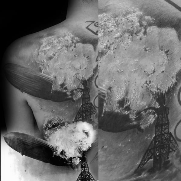 Realistic black and gray back tattoo of the Zeppelin airship explosion, with smoke and tower details, and Zoso symbol above.