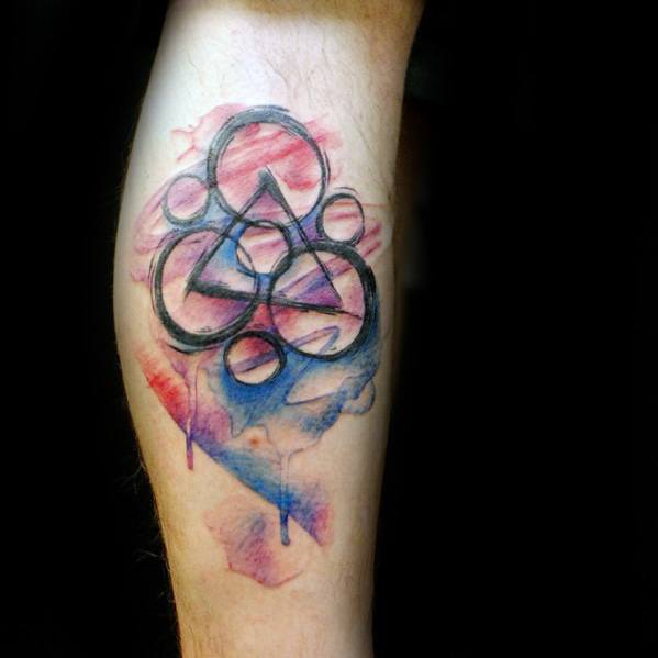 Coheed and Cambria Keywork tattoo with fine black lines over a soft red and blue watercolor background, giving it a dreamy artistic feel.