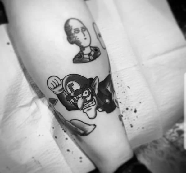 Black and grey tattoo of Waluigi in an action pose, featuring bold outlines and shading, placed on the leg alongside other designs.