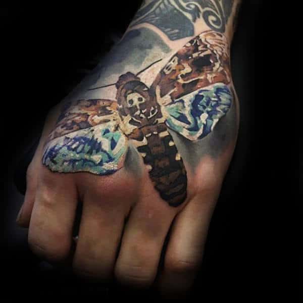 Creative Hand Tattoo Of Flying Moth