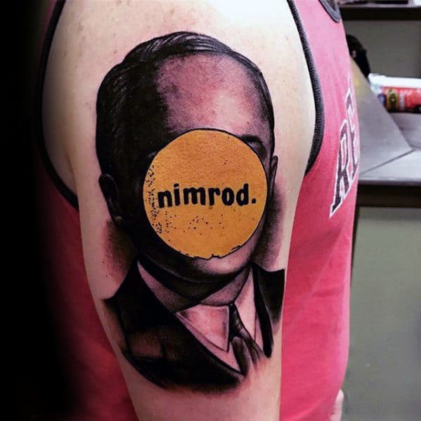 Tattoo of a headless suited figure with a bold yellow circle over the face reading “nimrod.” in homage to Green Day’s album.