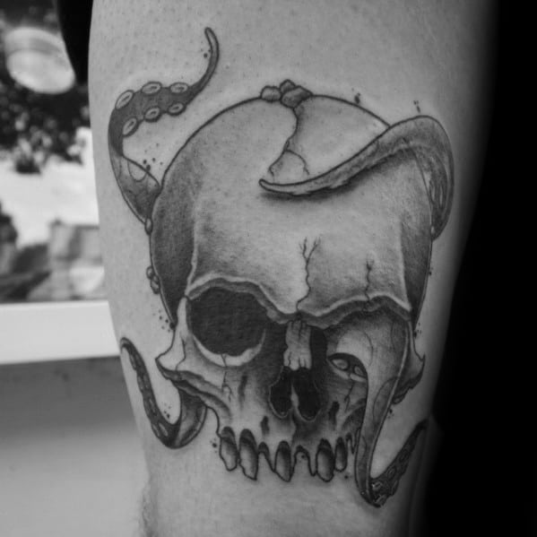 Octopus tentacle wrapping around a cracked skull, with detailed shading and contrasts, creating a bold and dark design.