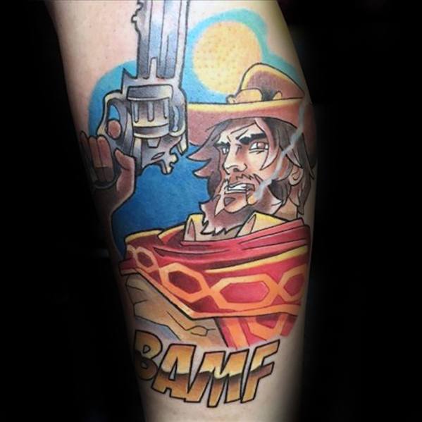 Vibrant tattoo of Cassidy from Overwatch aiming his revolver, with a bold BAMF text and desert backdrop on a man's leg.